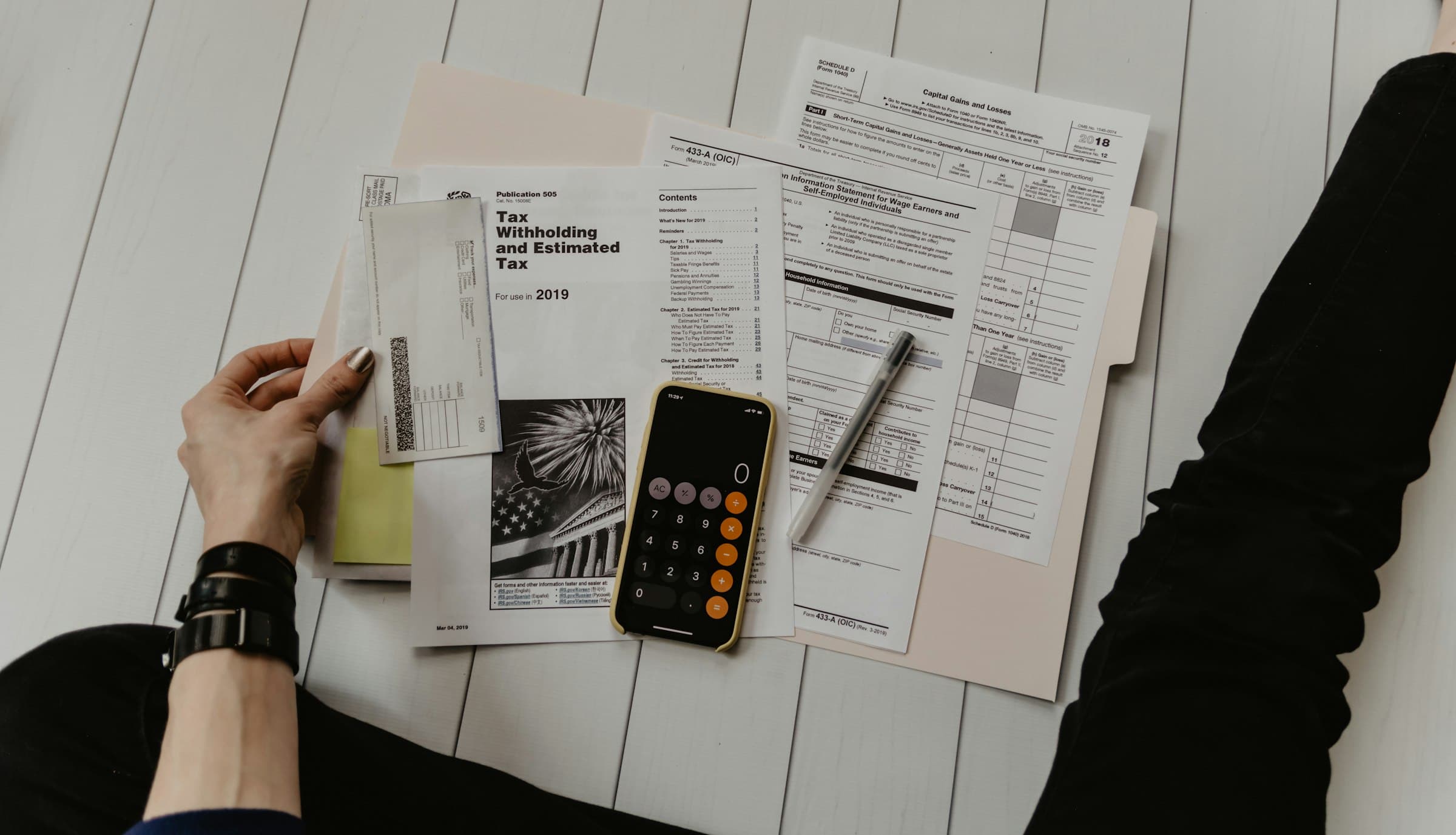 Calculator and financial documents on a desk, representing e-commerce website cost planning